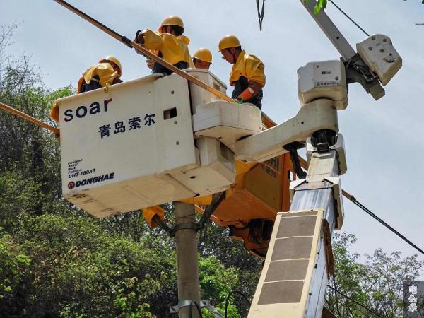 4月14日，在师宗县高良乡纳非村委会雨腊村，南方电网云南曲靖师宗供电局出动两台绝缘斗臂车，让周边近300户村民在“无感”的情况下，顺利完成10kV高科线雨腊支线28号杆带电直线杆改耐张杆作业。图为作业人员进行线路绝缘包裹。（孟锐勇 摄）