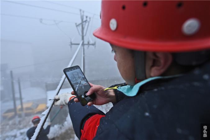 南方电网贵州六盘水盘州供电局党员正在对线路覆冰厚度进行记录 李开飞摄